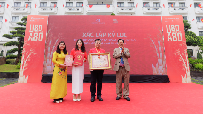 Đại diện ban tổ chức đón nhận bằng xác lập kỷ lục Việt Nam về sự kiện hát Quốc ca có số lượng người cao tuổi tham gia đông nhất.